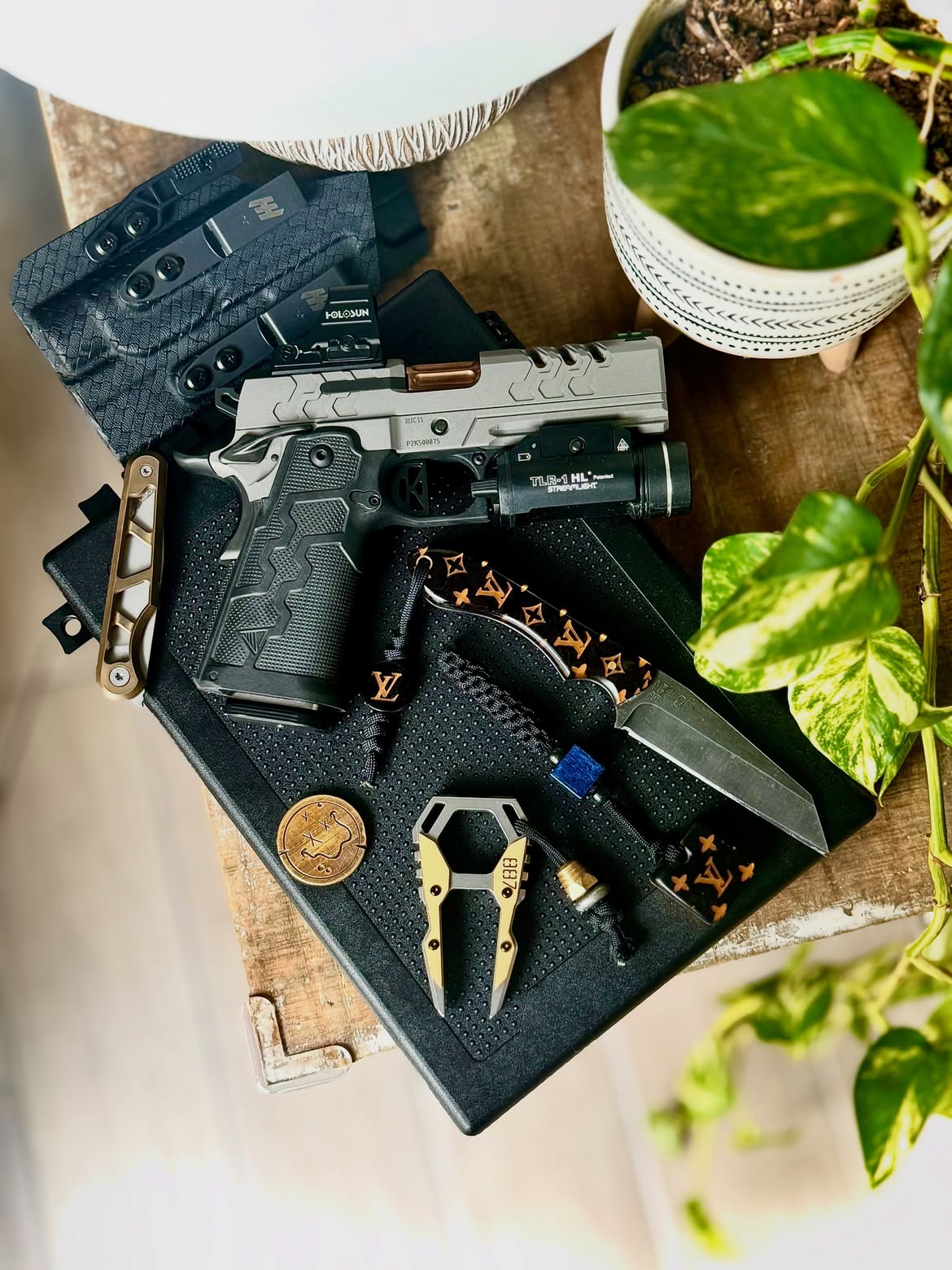 EDC layout with knife, coins and pocket tools on leather
